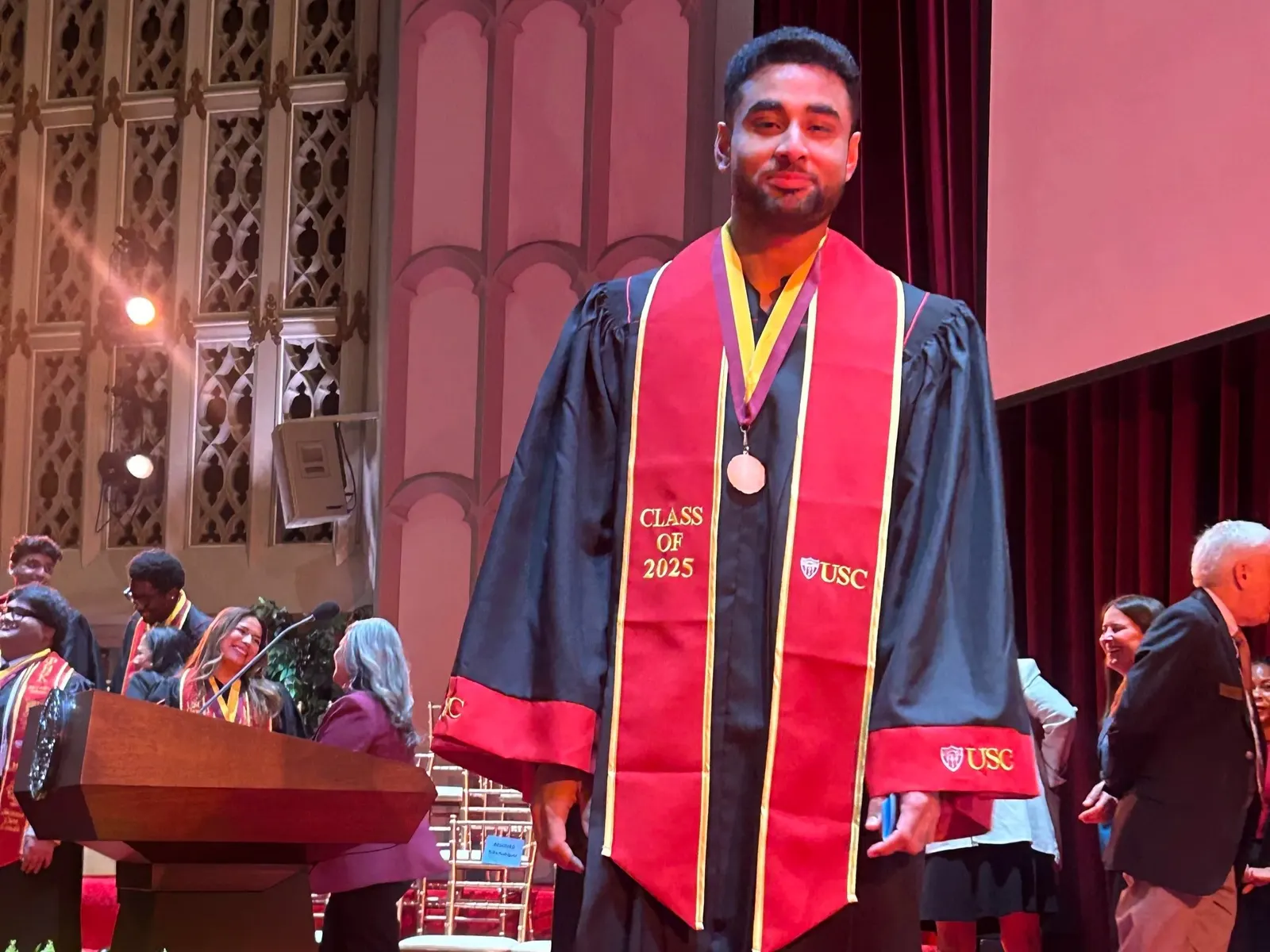Talha Rafique holding the Order of the Laurel and the Palm