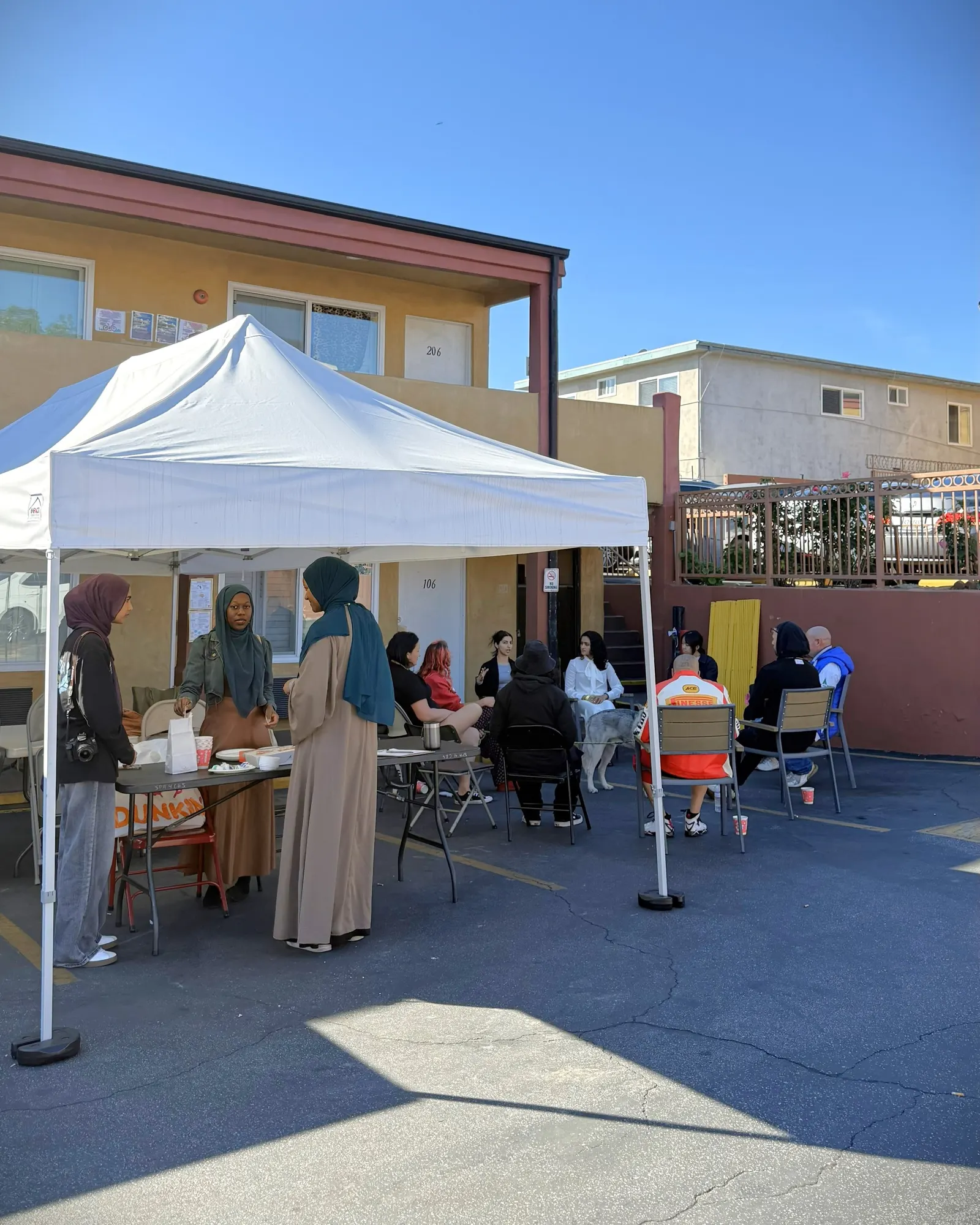Students leading a workshop under a tent at a partner shelter