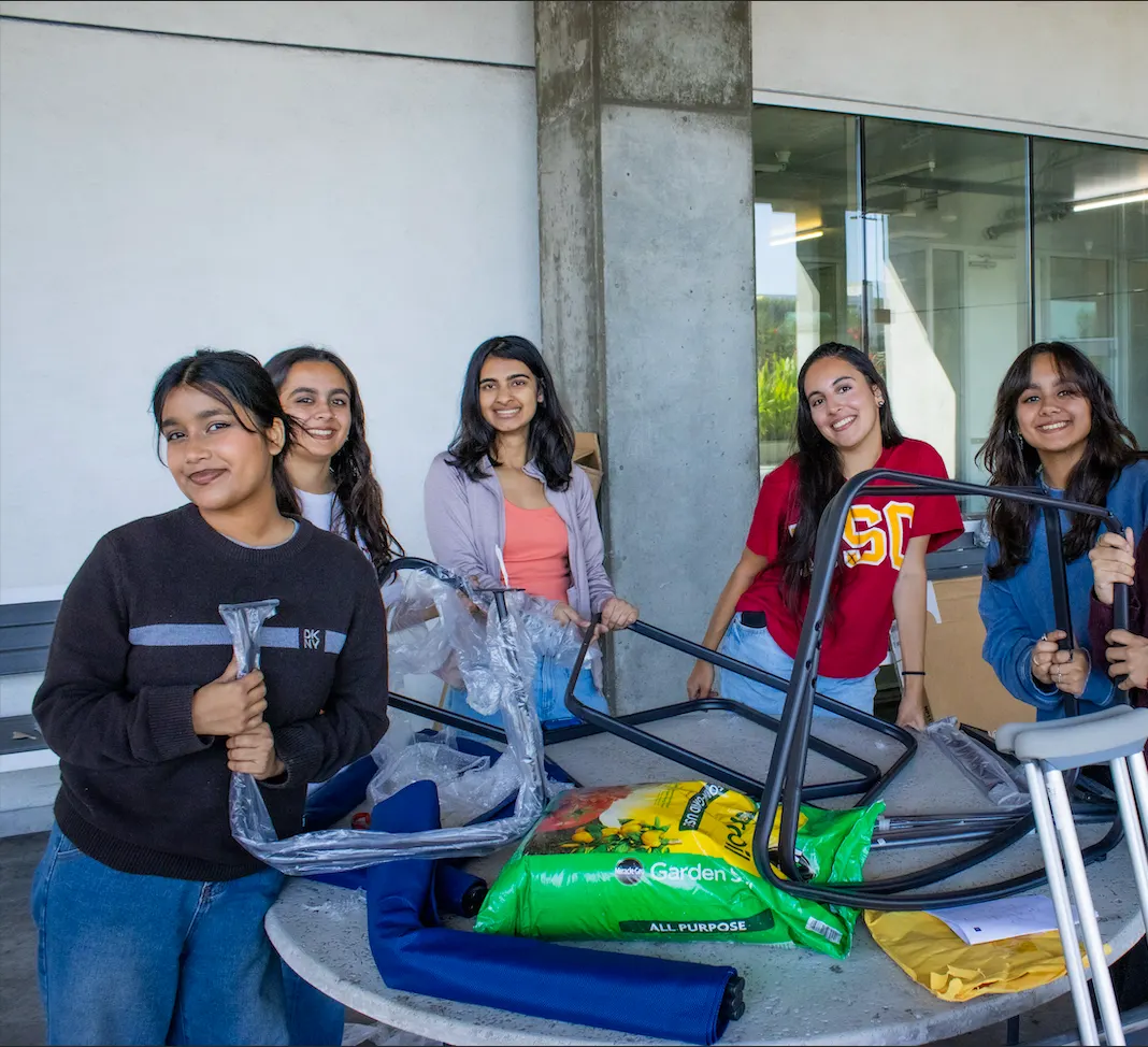 USC volunteers assembling furniture for the Wellness Project