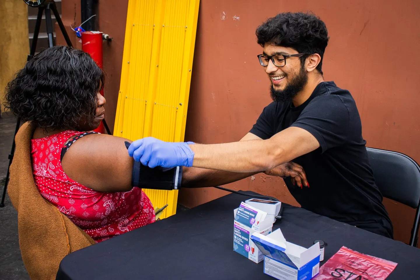 A USC student volunteer checks a resident's blood pressure at a pain management workshop